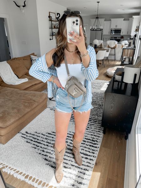 Must Have Amazon Button Down 🩵🤍 styled this striped button down with a western twist — would make a cute casual Nashville outfit or it’s also perfect for everyday wear! the lightweight material is perfect for summer — I sized up one for a more oversized fit! 

Tube Top — small
Button Down — medium
Shorts — 27

*my bag is the grey color option 

western outfit | western style | western fashion | country concert outfit | cowgirl boots outfit | western boots outfit | tecovas Annie boots | oversized striped button down shirt | high waisted jean shorts | high waisted denim shorts | smocked tube top 



#LTKShoeCrush #LTKStyleTip #LTKItBag