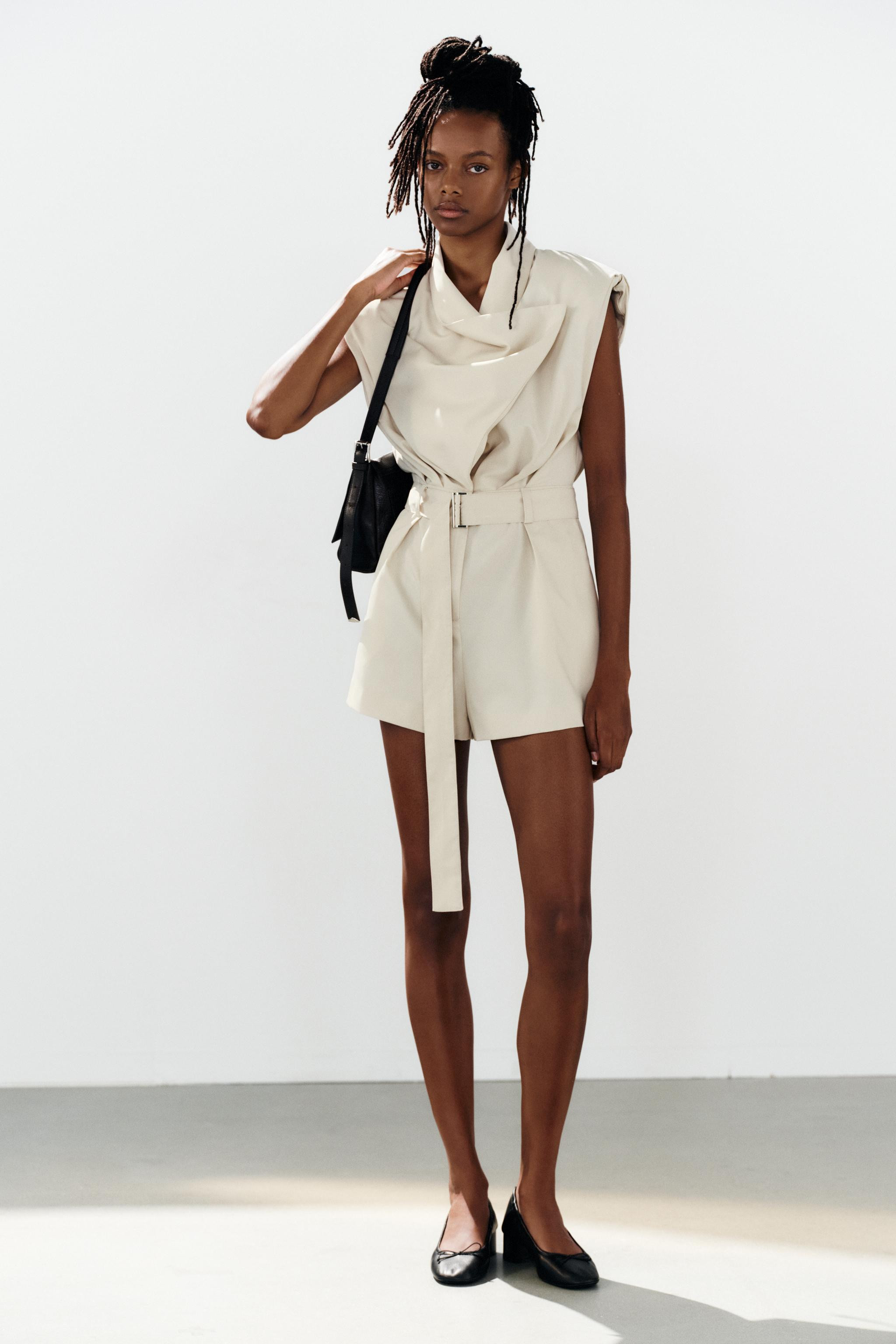 Short jumpsuit with a draped crossover neckline. Sleeveless design with shoulder pads. Features f... | Zara US
