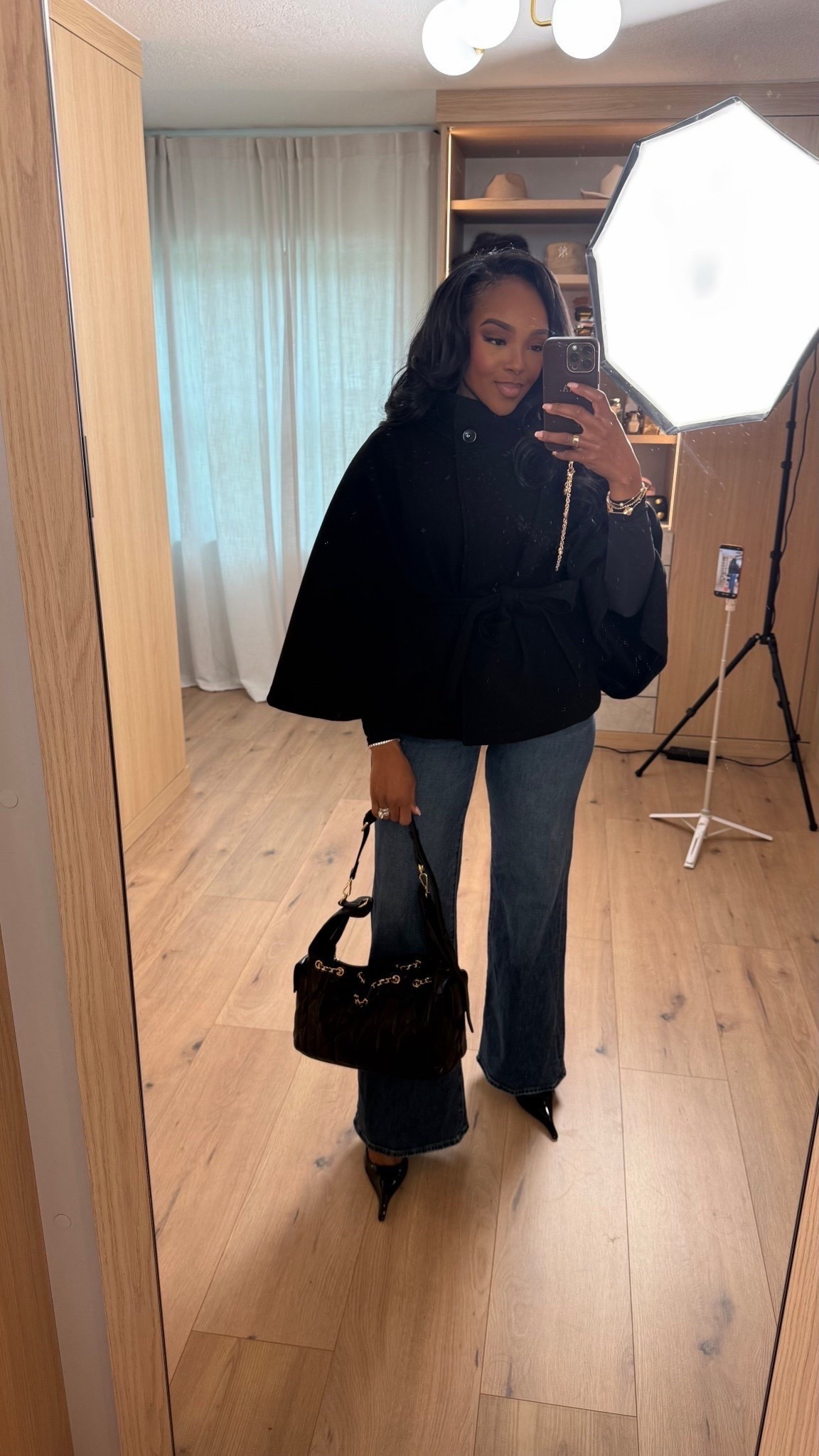 This is one of those outfits that instantly elevates your everyday denim — polished, flattering, and effortless without trying too hard. The structured cape-style top paired with classic jeans creates that chic work-to-dinner balance that always feels intentional.

This look is all about elevated basics that work hard in your wardrobe. The silhouette is timeless, the fit is flattering, and every piece can be styled multiple ways — which means the cost per wear drops fast. A great example of investing in versatile staples while mixing in affordable, designer-inspired accessories.

Perfect for office days, client meetings, dinner plans, or anytime you want to look pulled together without overthinking it.

📏 Sizing & fit details:  
Top: Size Small  
Jeans: 27 Long  
Shoes: True to size  
Bag: Structured, medium size

Measurements: 5'4", 138 lbs, 34D bust, 27" waist, 40" hips

This outfit works beautifully for workwear outfits, polished everyday looks, capsule wardrobe styling, classic neutrals, elevated basics, designer-inspired handbags, and chic casual outfits that transition seamlessly from day to night.

Follow me on Instagram and YouTube @kirasfashionfinds 

#LTKPetite #LTKootd