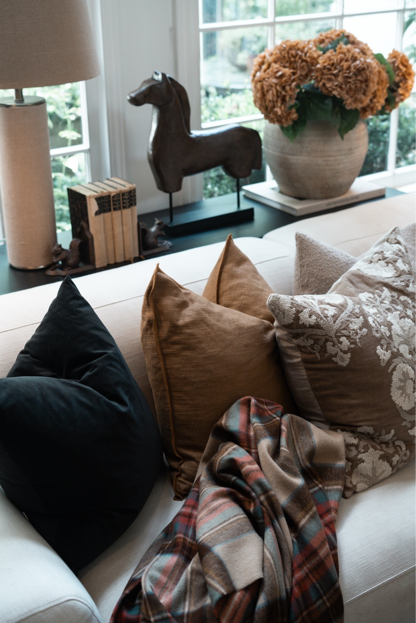 A tartan blanket, a mix of fall hued pillows, antique books, squirrel bookends, a linen lamp, and a textured vase with fall hydrangea? Does it get any better??!! Eeekkk!!

#LTKSeasonal #LTKSaleAlert #LTKPetite