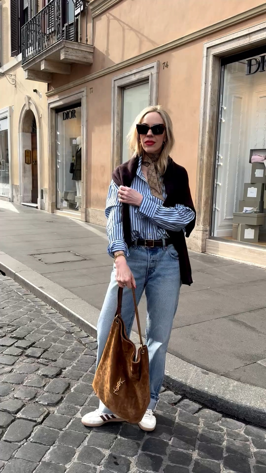 Spring outfit, @Zara striped shirt, @Levi's baggy 90’s jeans, Adidas Samba sneakers, suede YSL tote bag, European vacation, spring break travel style 

#LTKTravel #LTKSaleAlert #LTKSeasonal