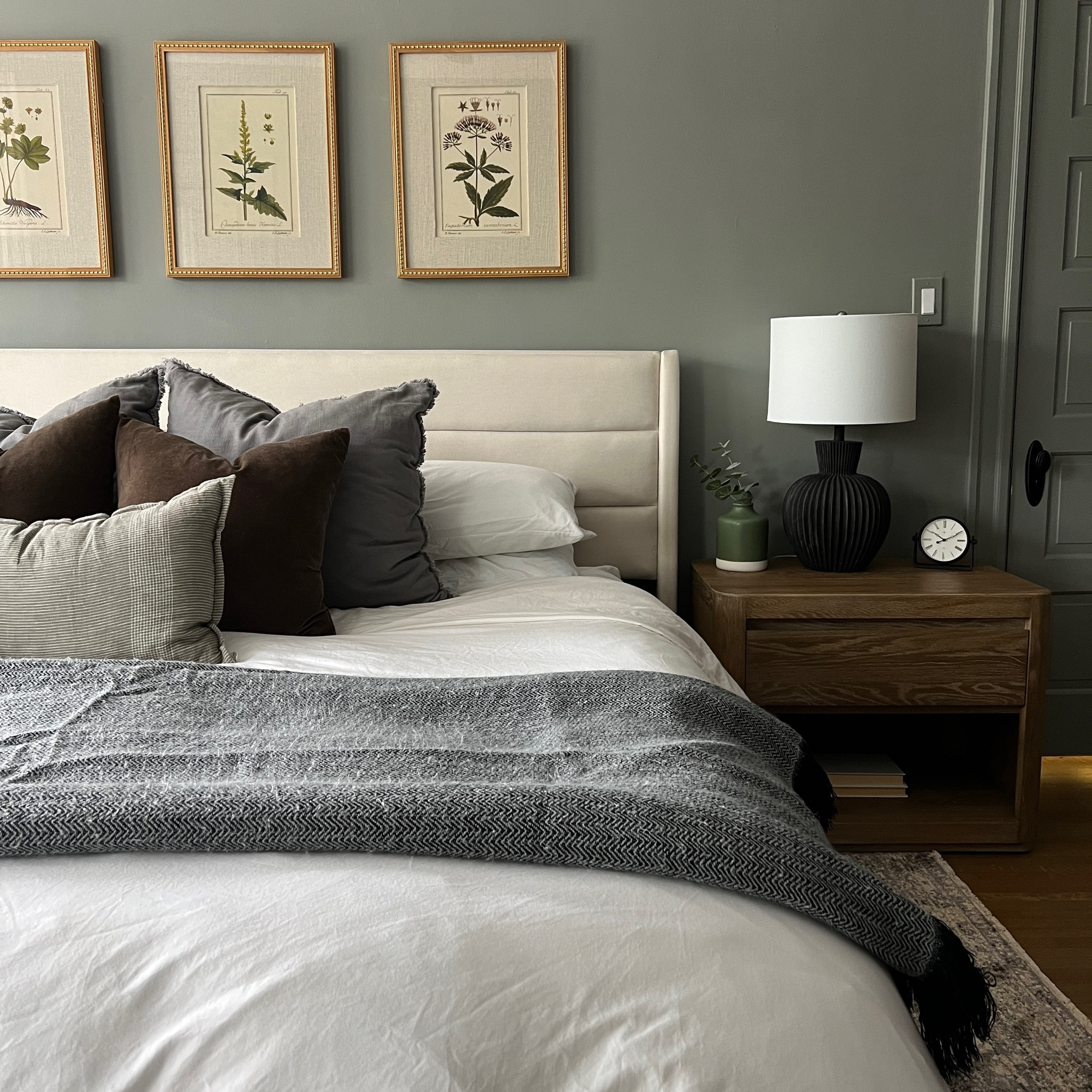 Cozy primary bedroom. Paint color is SW Illusive Green