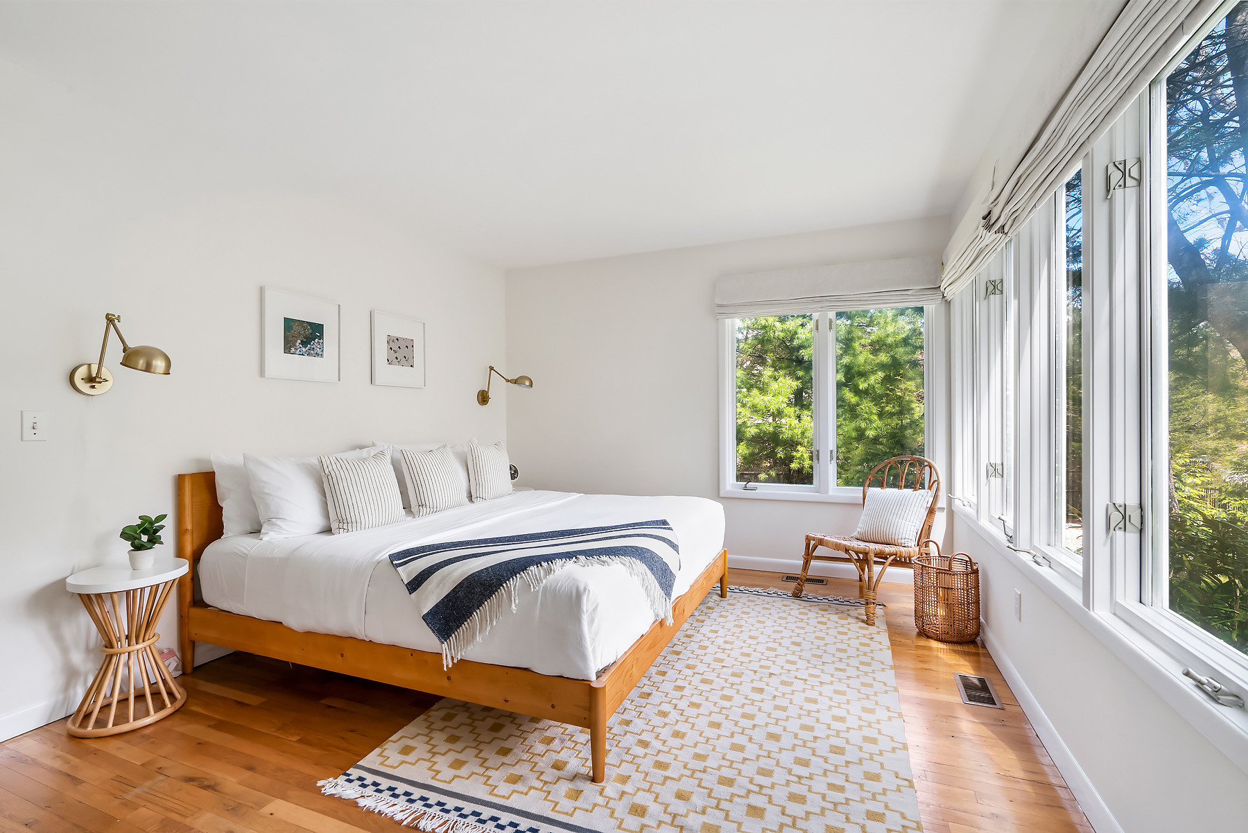 Bedroom with a wood frame, brass sconces, woven side table and a pattern rug. Linking exact and similar pieces here.

#LTKSaleAlert #LTKHome