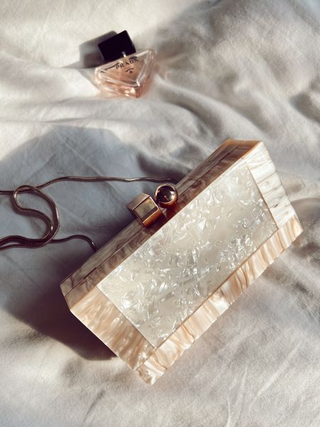 This clutch is everything! Giving all the Cult Gaia vibes. Pair it with your favorite summer outfit and you’re good to go! 
I love that it comes with two different detachable chain straps. 

#LTKstyletip #LTKunder50 #LTKitbag