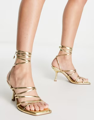 ASOS DESIGN Hiccup strappy tie leg mid heeled sandals in gold | ASOS (Global)