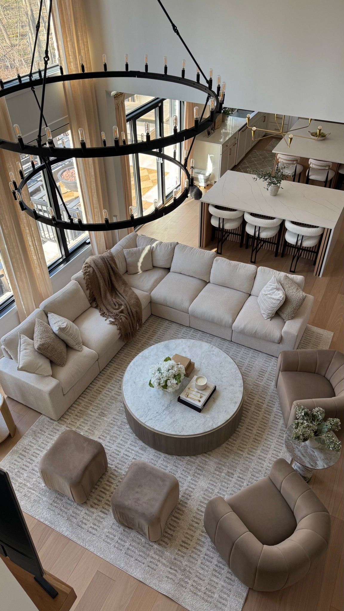 Neutral living room rug, sectional, velvet accent chairs, round marble top table.

#LTKHome #LTKSaleAlert