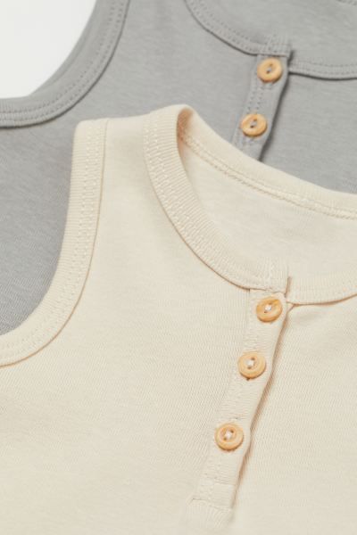 Baby Exclusive. Sleeveless bodysuits in soft cotton jersey. Buttons at top and snap fasteners at ... | H&M (US + CA)