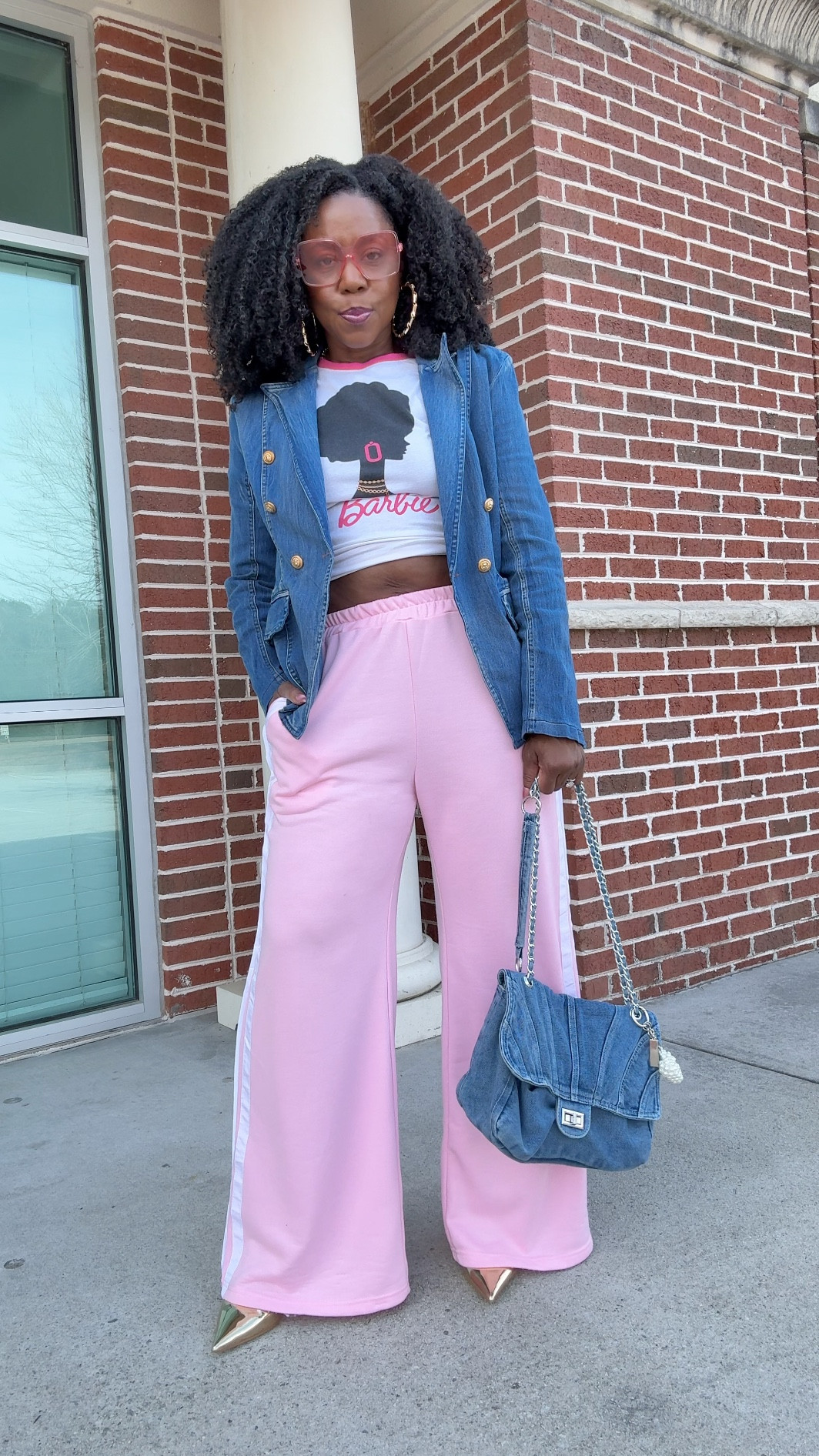 Athleisure but she has somewhere to be. Pink  Athleisure OOTD.  🌸✨

Comment PINK for the link 💗

Sporty wide-leg track pants…
Graphic Black Barbie tee…
Structured denim blazer to pull it together…

Paired with gold metallic sling backs and a denim bag because, baby, details matter.  ✨

Everything’s linked. Comment PINK for the link. 

.

.

.

.

.

#MikoSlaysFashion #SportyChic #AthleisureStyle #WideLegPants #RichAuntieVibes #LTKFinds #BlackBarbie #EverydayGlam #StreetStyleInspo #fyp

#LTKActive #LTKootd #LTKOver40