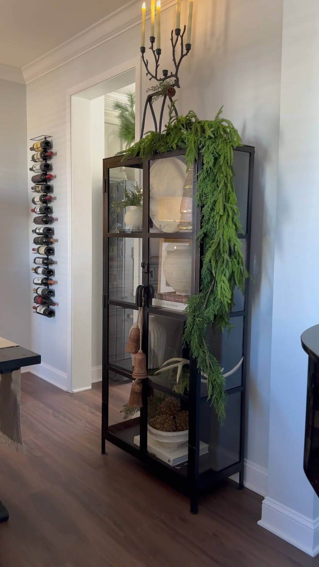 Simple oversized wreath over my mirror, garland draped over my cabinet and a candelabra centerpiece for my dining table and my Christmas look is complete for 2025!

#LTKSeasonal #LTKHome #LTKHoliday