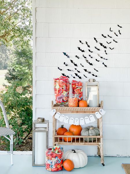 Create your own trick-or-treat bar cart on your front porch! I set up our bar cart with big bowls and vases full of candy! I added pumpkins, brass lanterns, and sticky bats fora little drama! 

#LTKHalloween #LTKSeasonal