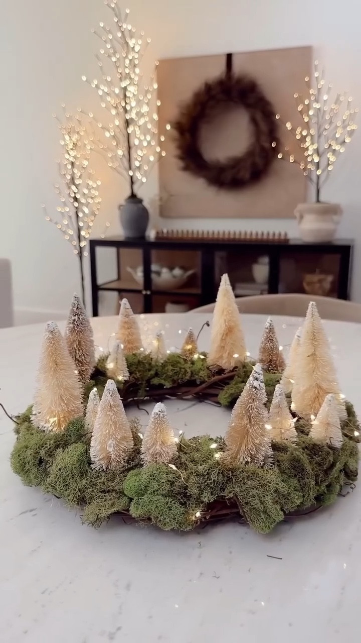 This DIY Christmas centerpiece is giving all the Anthropologie vibes without the price tag. I started with a simple wreath base, added layers of preserved moss, tucked in a few white bottle brush trees, and wrapped it all with twinkle lights. It’s the easiest way to make your table feel festive, organic, and so beautifully magical — like something straight out of a cozy cottage holiday dinner scene.

anthropologie christmas dupe, diy christmas centerpiece, neutral christmas decor, modern cottage christmas, organic modern christmas, christmas table decor, moss centerpiece, bottle brush trees, twinkle light centerpiece, rustic elegant holiday, european inspired christmas, cozy holiday home, cottage christmas style, pottery barn christmas dupe, lulu and georgia christmas, scandinavian christmas decor, natural holiday tablescape, winter centerpiece ideas, cozy christmas decorating, timeless holiday decor

#LTKHoliday #LTKHome #LTKSeasonal