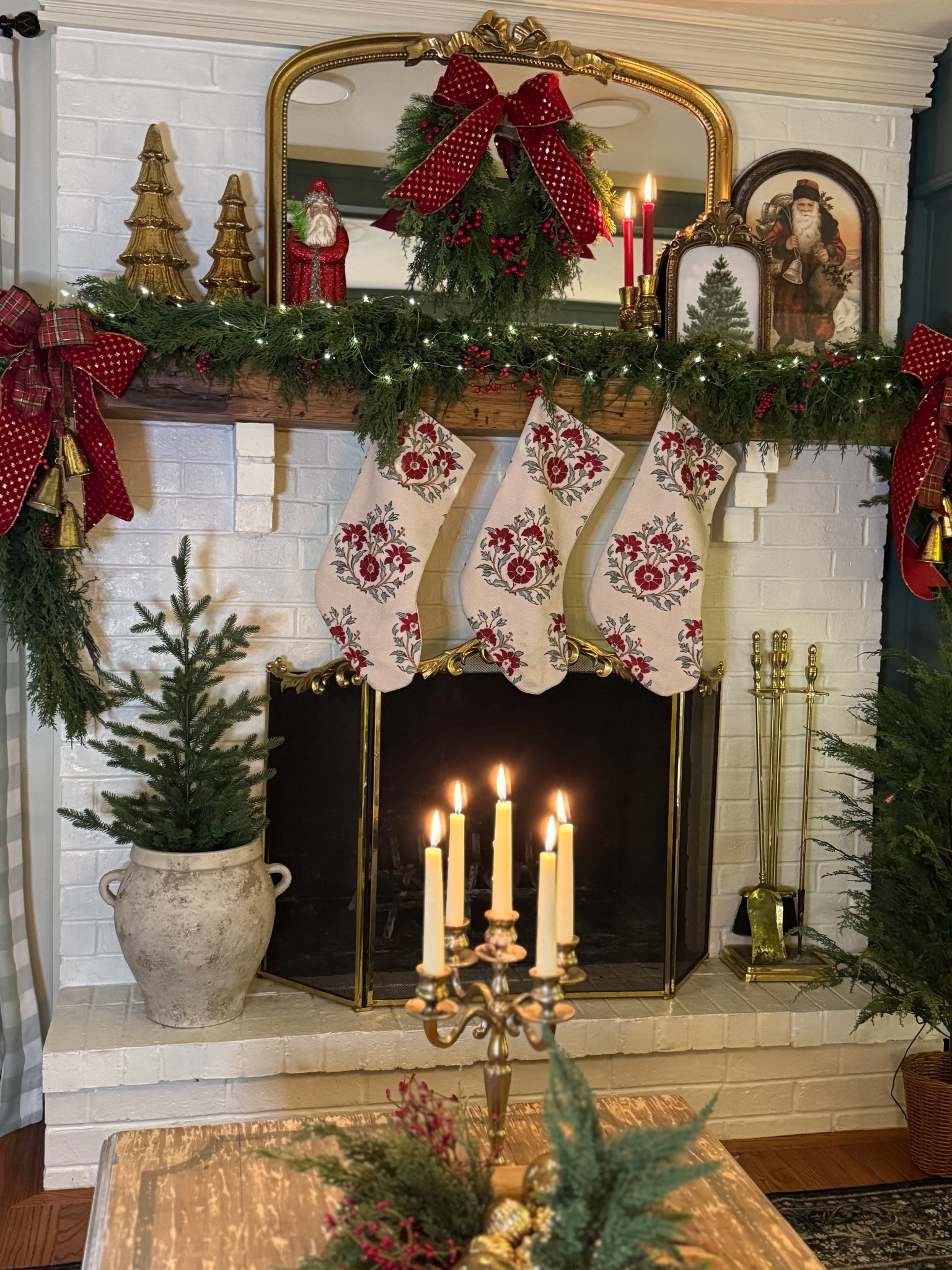 Christmas mantle decor.. this large legume pot gets used year round. Block print beaded Christmas stockings, garland, wreath, Santa art 

#LTKFindsUnder50 #LTKHoliday #LTKHome