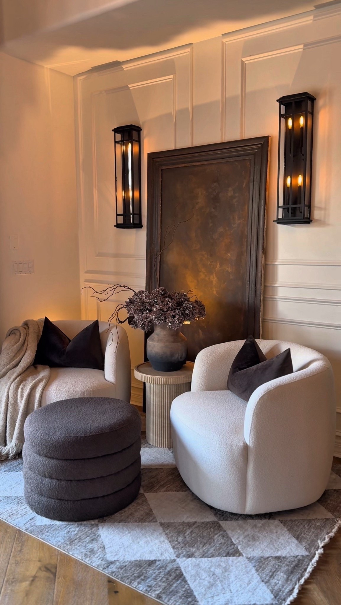 A moody brown corner in my home featuring my favorite cozy swivel chairs, a textured ottoman, and a statement vase I love. The mix of warm tones and soft lighting makes this spot feel so inviting, with the small details like the end table and artwork tying it all together.🥰

#moodyinteriors #neutraldecor #cozycorner #warmtones #modernhome

#LTKFindsUnder100 #LTKFindsUnder50 #LTKHome