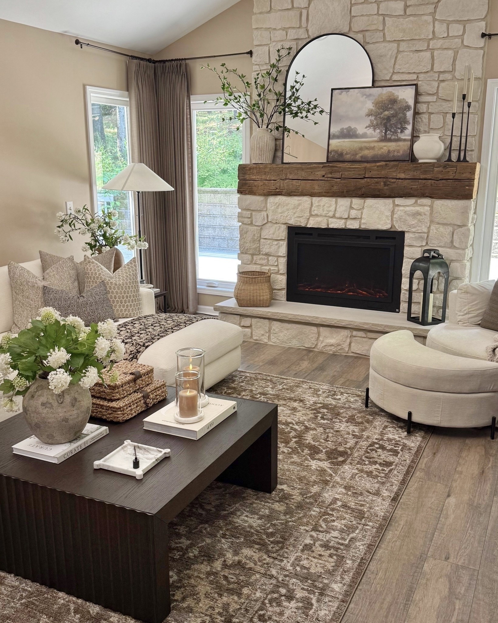 Warm Neutral Living Room Styling

Follow @farmtotablecreations on Instagram for more home décor inspiration.

This cozy living room moment is all about layering warm neutrals, natural textures, and timeless pieces that make a space feel collected and inviting. The oversized round mirror, rich wood console table, textured ottomans, statement lamp, and organic florals create the perfect balance of warmth and sophistication.

If your living room feels unfinished, adding a styled console table behind seating can instantly add depth, character, and function to the space.

#livingroom #consoletable #homedecor #mirror #vase

#LTKHome #LTKSaleAlert