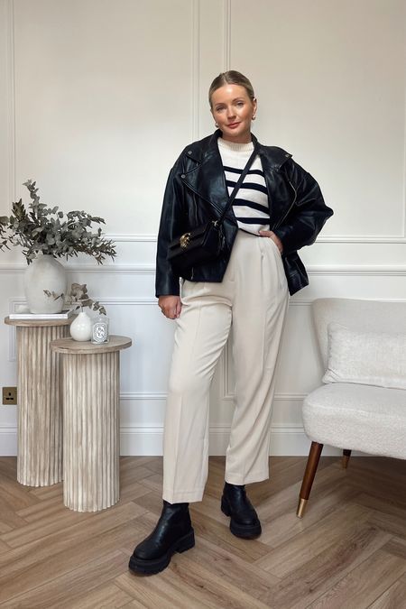 Black and cream autumn outfit / black leather jacket / cream tailored trousers / stripe knit 