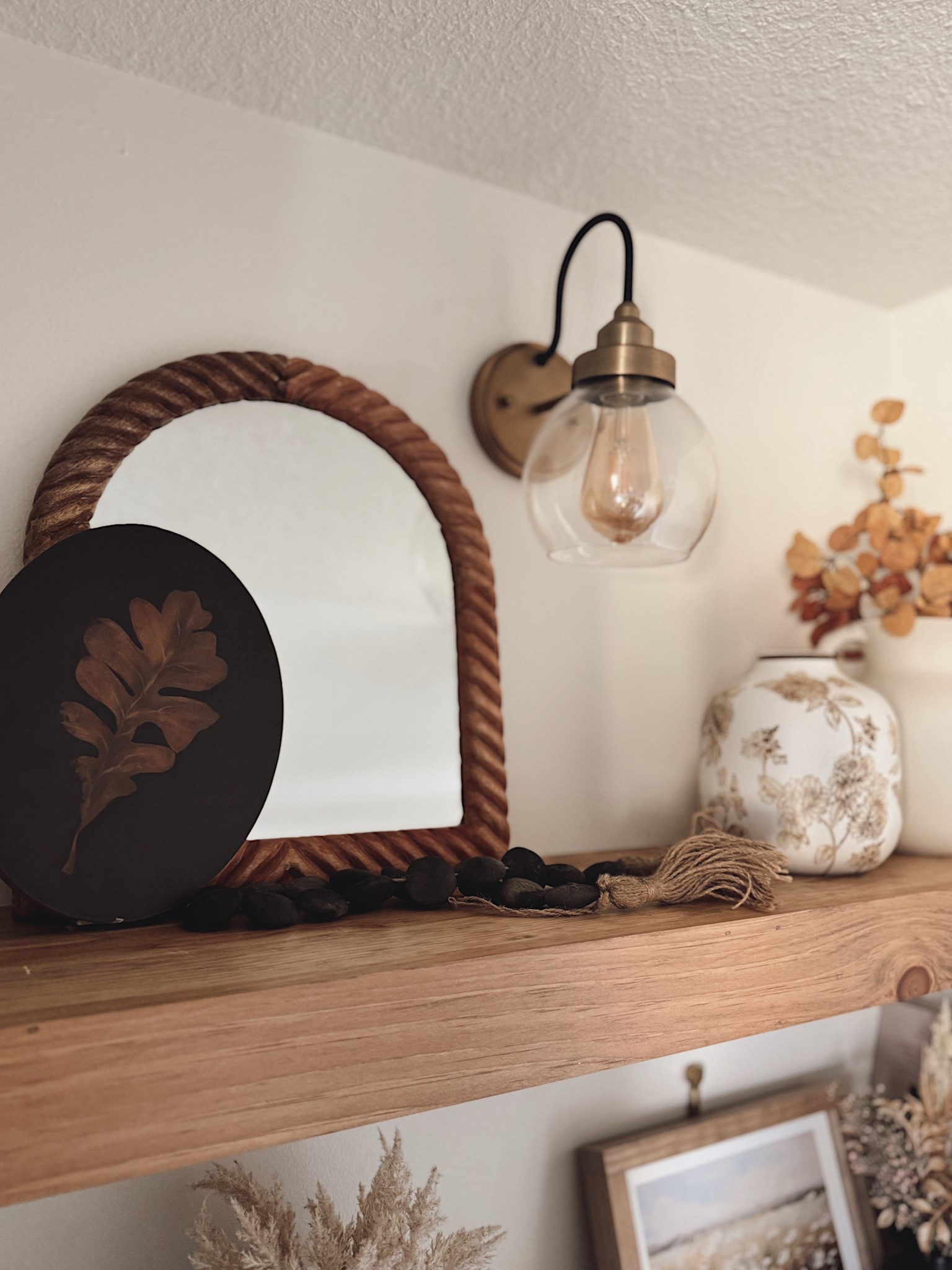 Layered shelf styling 🤎✨ Mixing textures like wood, rope, glass, and ceramic makes a shelf feel collected and cozy instead of cluttered. I love pairing mirrors with smaller accents (like beads + vases) to create depth and balance. 

#ltkhome #shelfdecor #neutraldecor #homestyling #ltkfinds #cozyhome