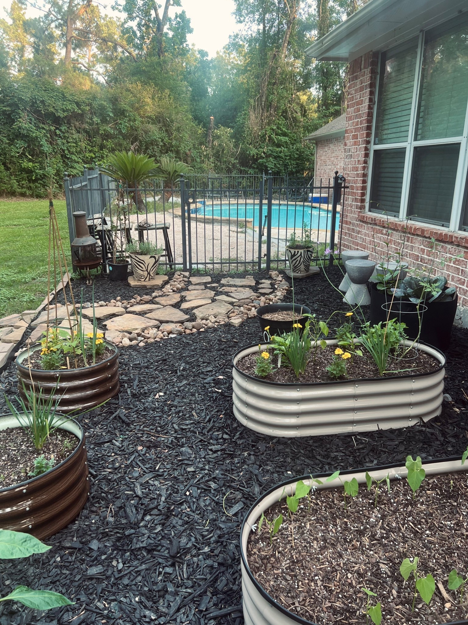 Garden goals | love how it turned out. The taupe and brown combo is super calming against the natural landscape and black mulch. I could sit out here so day. #gardening #gardeninspo #raisedgarden #homegarden

#LTKFindsUnder50 #LTKHome #LTKSeasonal