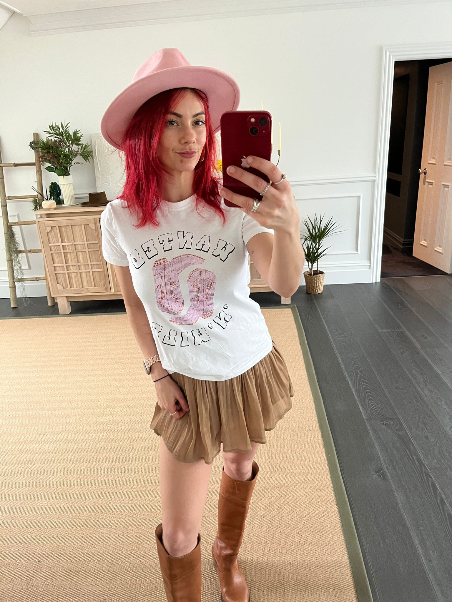 Pink cowboy boots, white graphic t-shirt, brown pleated skirt, tan knee high boots 

#LTKeurope #LTKstyletip #LTKFestival