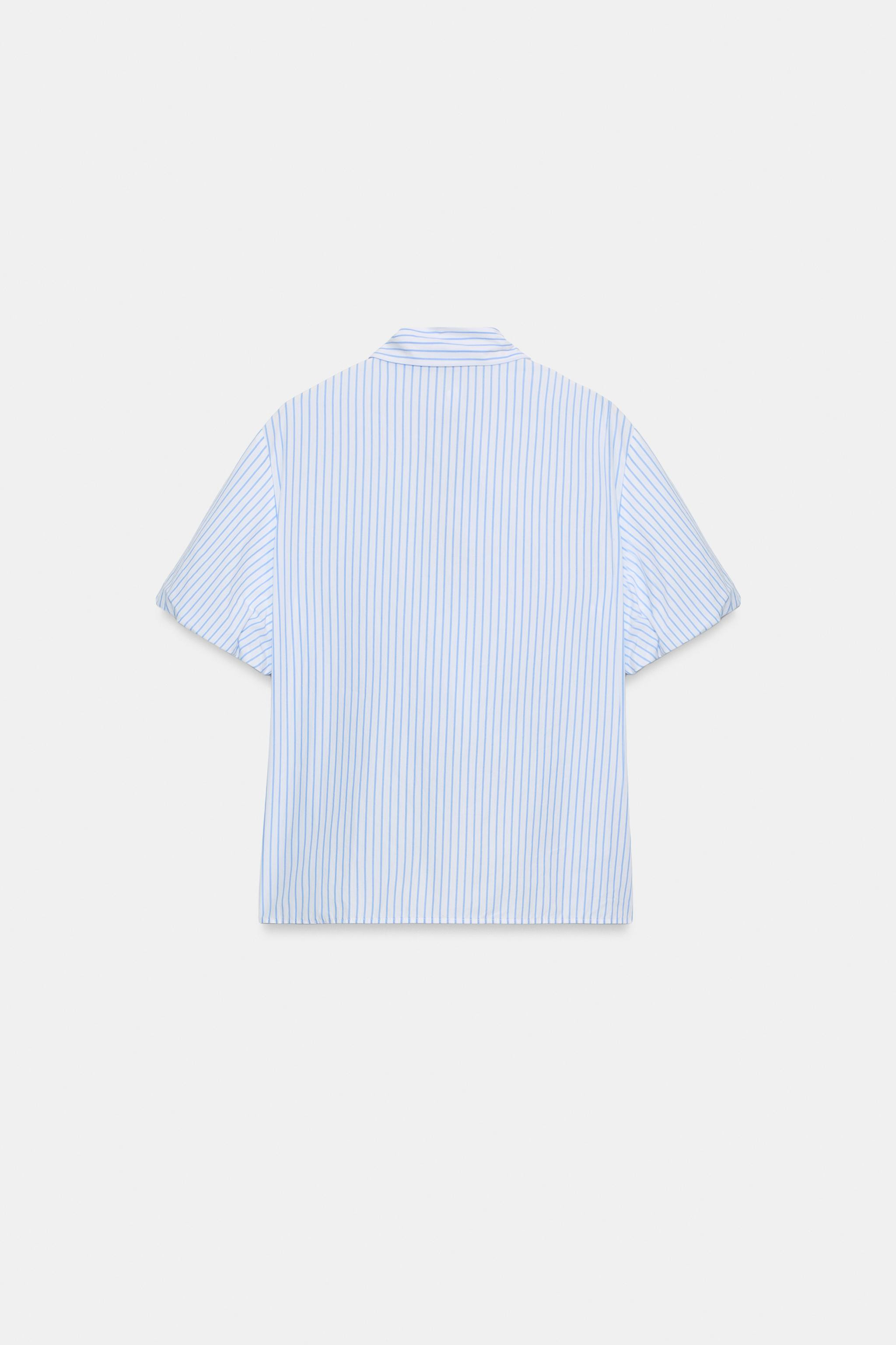 Top with a bow neckline, V-neck, and short puff sleeves with interior elastic cuffs. Front button... | Zara DE