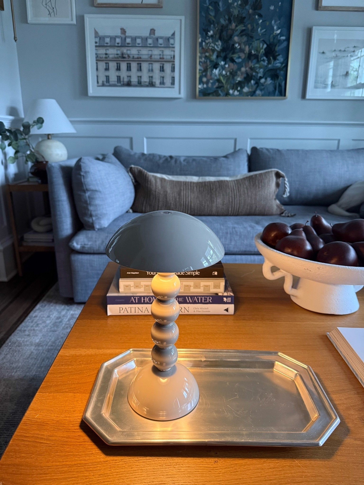This little coffee table setup is one of my favorite combinations. The sculptural lamp, silver tray, stacked coffee table books, and bowl of pears create the perfect mix of texture, warmth, and collected details.

coffee table decor, coffee table styling, sculptural table lamp, silver tray, coffee table books, decorative bowl, faux pears, living room decor, fall home decor, collected home style, timeless interiors, girlonthehudson