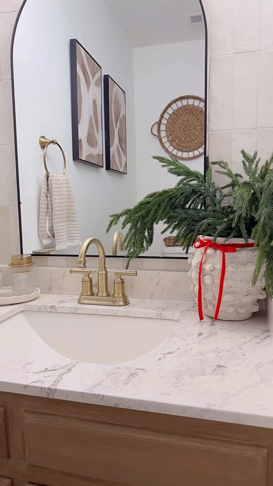 My powder room with a few festive touches for the season:

Seasonal candle 
Seasonal soap in a pretty dispenser 
Greenery stems
Velvet bow
…
You like also add a seasonal hand towel. 

#LTKHome #LTKHoliday #LTKSeasonal