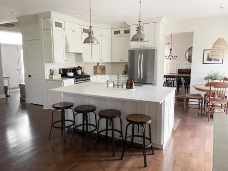 Our kitchen footprint is actually small but the open layout and large island makes it feel bigger.  


White kitchen.  Kitchen wooden industrial bar stools.  Kitchen fire clay 33” farmhouse sink.  Satin nickel bridge kitchen faucet.  Amazon kitchen brushed nickel hardware.   