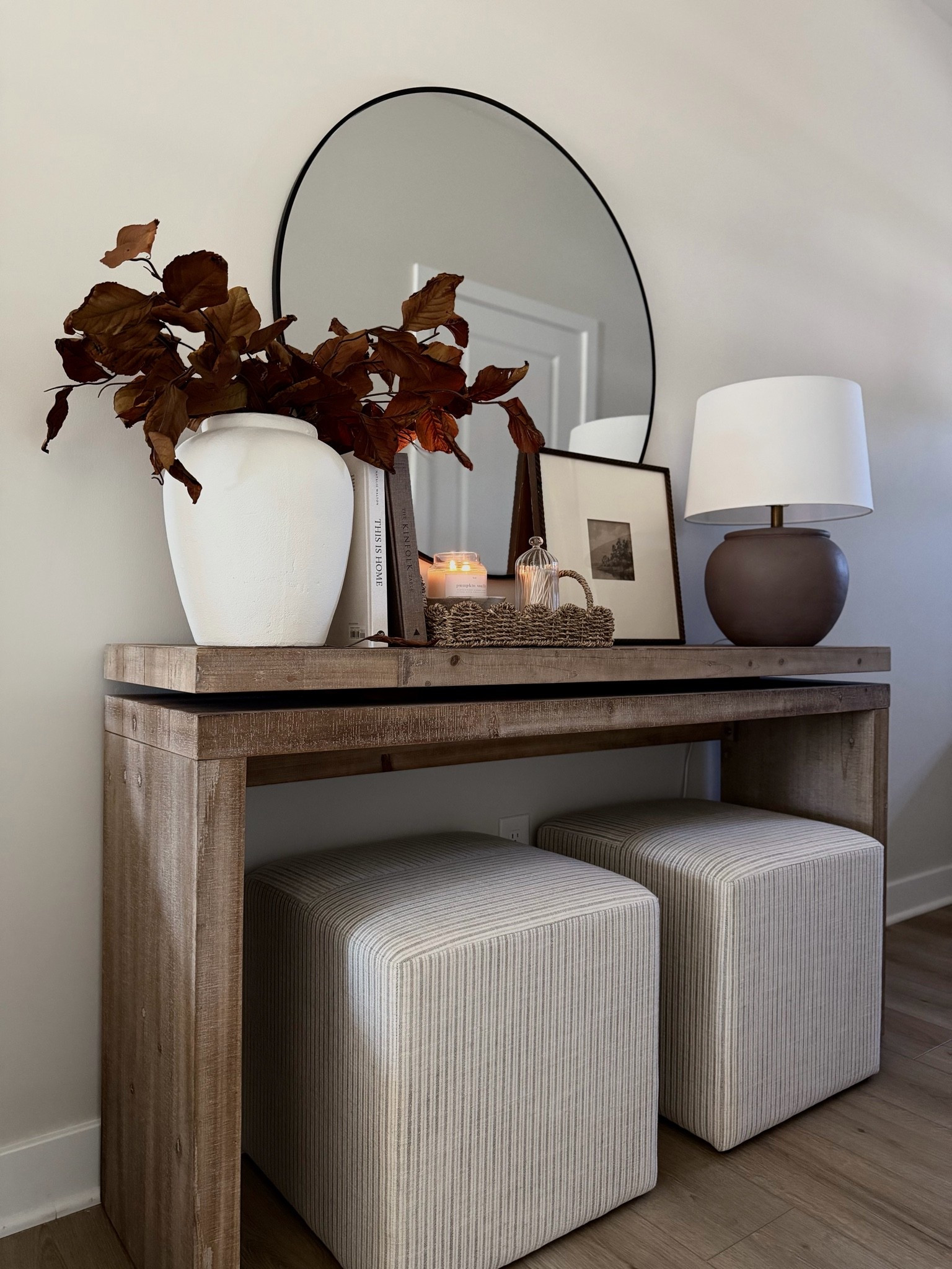 Fall console, fall magnolia stems, ottomans, round mirror, wood console table, cream vase, scallop tray, candle bowl, fall console styling

#LTKSaleAlert #LTKHome #LTKSeasonal
