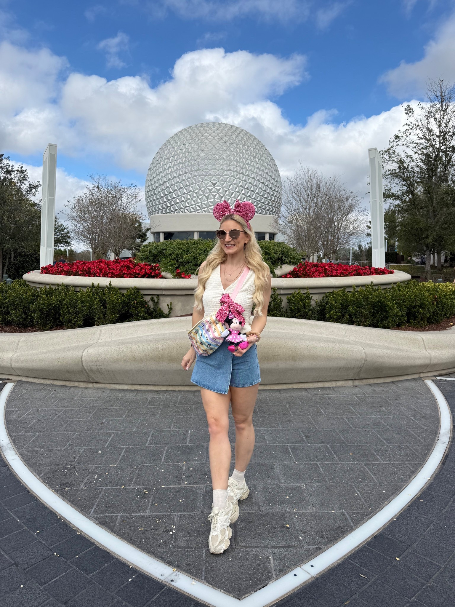 Simple Epcot Outfit with all the accessories 🤭
Pink Sparkle Ears and Bag Bow..
https://earseverafter.com/search?q=pink+sparkle&options%5Bprefix%5D=last
Bag is Stoney Clover Lane but it’s sold out! 