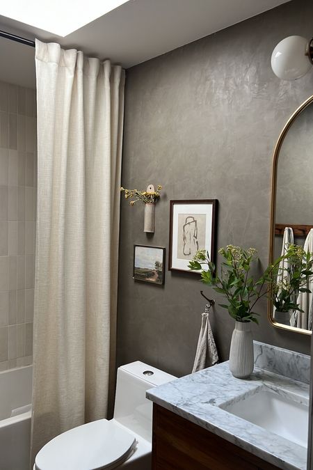 Ditch the shower curtain and create a luxe look in your bathroom by using a window curtain and hanging it close to the ceiling! 

#LTKhome