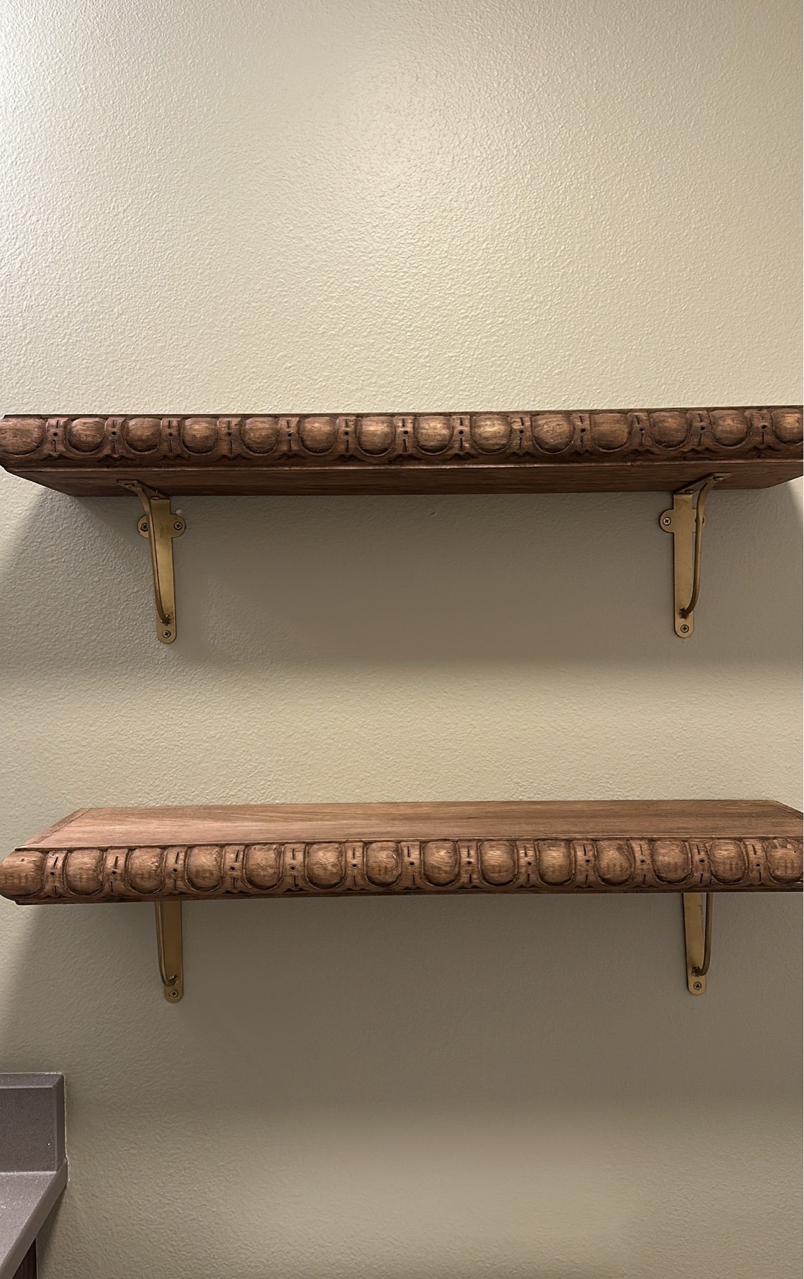 Wood bathroom shelves with brass brackets

#LTKHome
