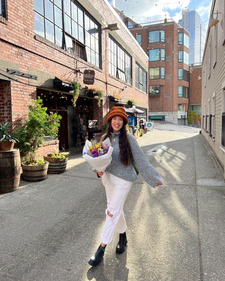 Sweater weather in Seattle ✨ Walked 7+ miles in these waterproof boots! 🙌🏽 black boots, black booties, ugg boots. Revolve sale, agolde jeans, white jeans are 50% off. Womens winter hat. Target sweater. 

#LTKtravel #LTKsalealert #LTKSeasonal