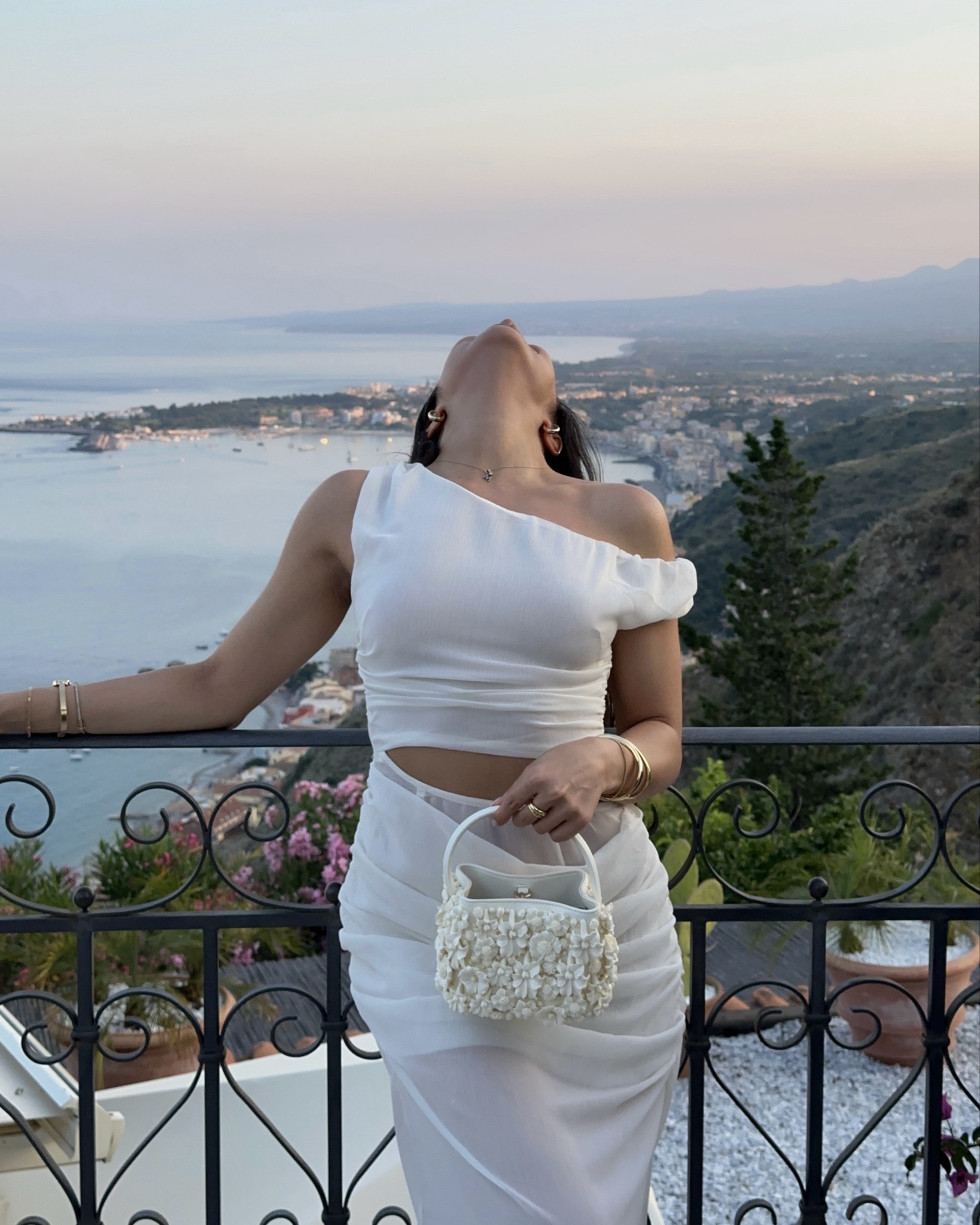 White maxi dress with cutouts paired with my favourite little flower bag

#LTKsummer #LTKdresses #LTKtravel