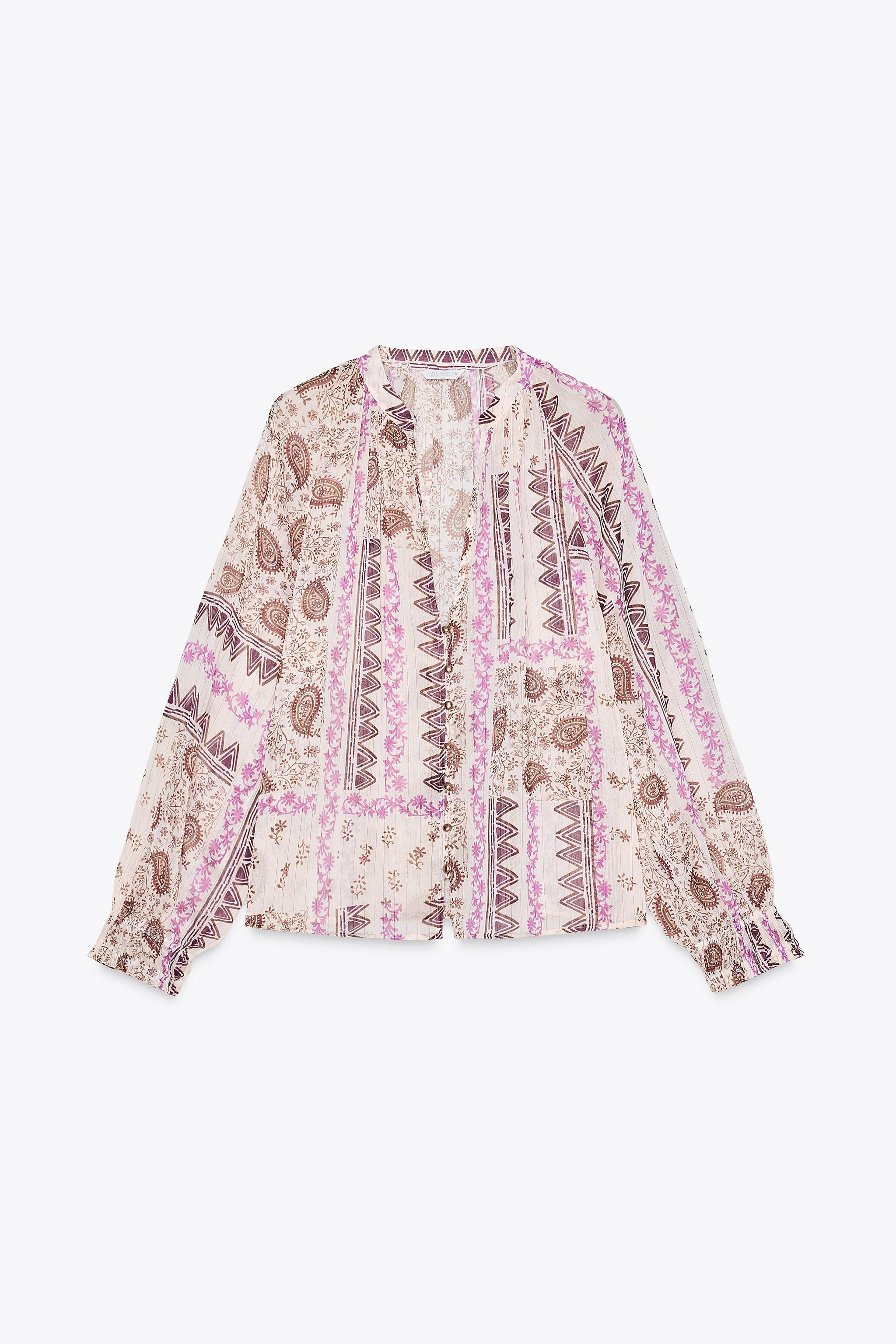 Round neck blouse with a V-neck and long sleeves with elastic cuffs. Semi-sheer metallic thread p... | Zara US