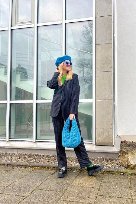 Pinstriped Suit. Fashion Blogger Girl by Style Blog Heartfelt Hunt. Girl with blond hair wearing a pinstriped suit, blue beret, blue oversized sunglasses, green T-shirt, blue statement bag, green socks and chunky loafers. #pinstriped #springlook #colorfuloutfit #colorfulstyle #colorfulfashion #colorfullooks #fashionfun #cutespringoutfit #springfashion2023 #springlookbook #fitcheck #dailylooks #dailylookbook #contentcreator #microinfluencer #discoverunder20k