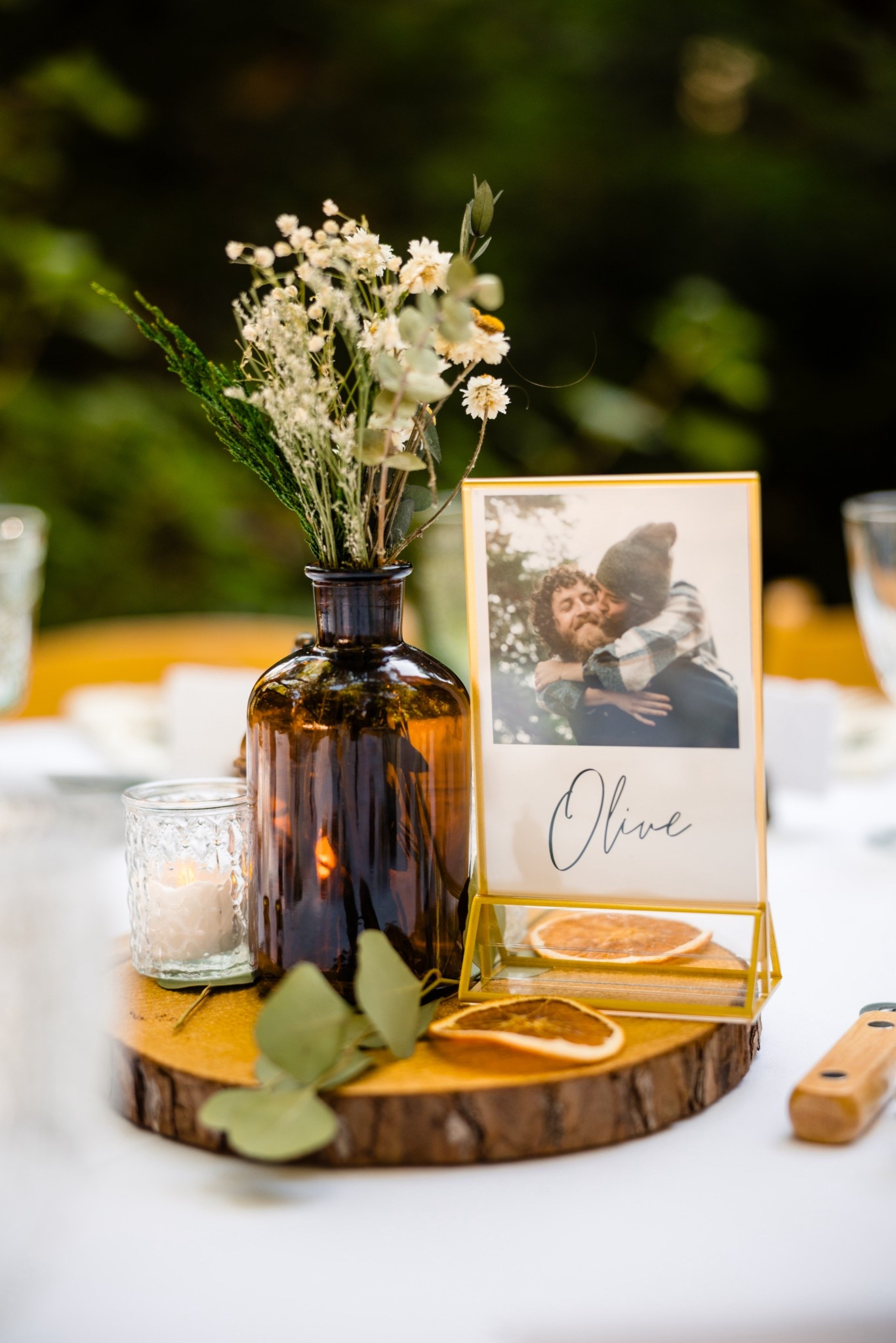 Our Wedding Centerpieces turned out beautifully! I planned every detail from the unique tree table names with our favorite photos, wildflowers in the amber vases, orange slices and eucalyptus on the wood slab underneath it all, candles and lanterns placed strategically on a diagram I made for the day of coordinator. We also placed wood bottle openers for the apple cider bottles on the table tables with an eclectic blend of amber, clear, and green crystal goblets. I am so proud of what we created. #wedding #weddingcenterpiece #weddingtable #weddingideas #centerpieces #centerpieceideas

#LTKWedding