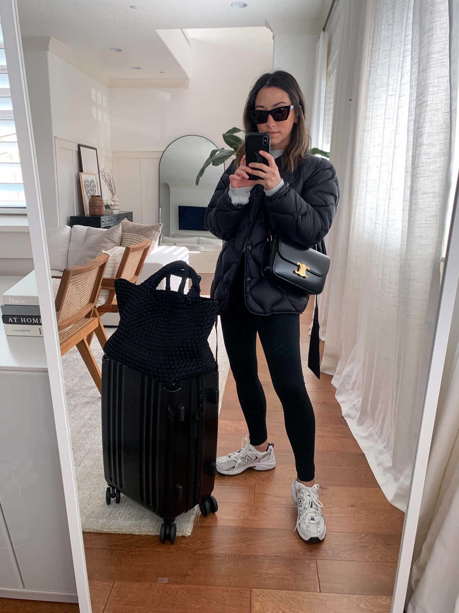Travel airport style. Airport travel outfit ideas. Comfy travel outfits. 

Jacket - Rag & Bone xxs
Sweatshirt - Anine Bing xs
Leggings - Zella xs
Sneakers - New Balance 4.5 men’s. 
Bag - Celine Triomphe medium 
Tote -  Naghedi medium
Carryon - Calpak