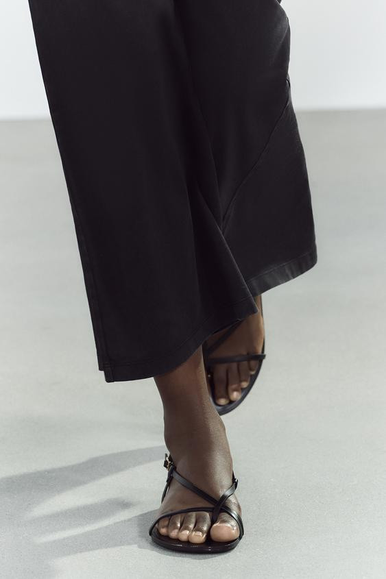 FLAT SANDALS WITH METALLIC DETAIL$ 49.90Black | 3618/510/800Add to cartAddFlat sandal-style shoes... | Zara US