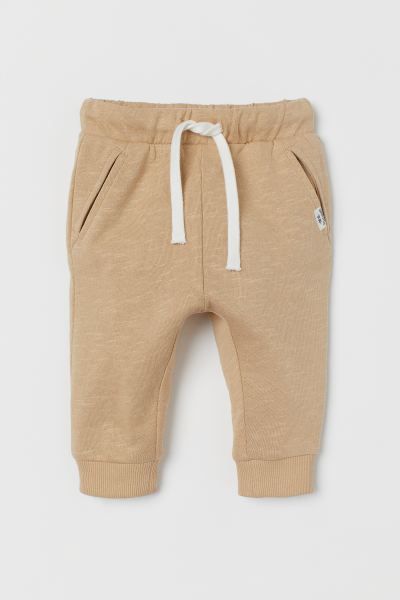 Sweatpant joggers in soft cotton with an elasticized, drawstring waistband, pockets, and ribbed h... | H&M (US + CA)
