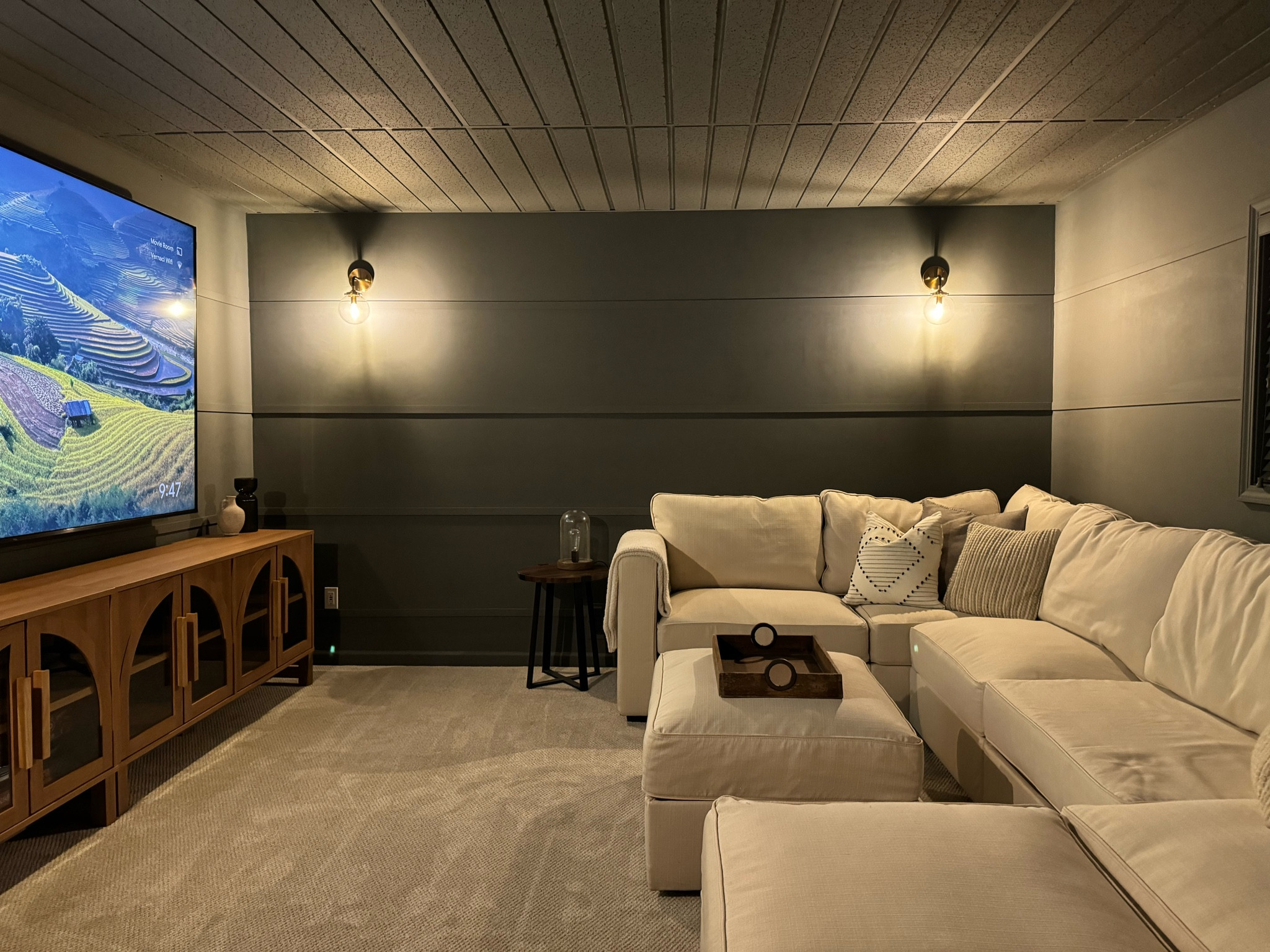 Movie room sources! Lovesac modular sectional couch, Walmart viral arch sideboard cabinet, gold accent sconce lights. Wall color is grizzle gray by sherwin Williams!

#LTKHome