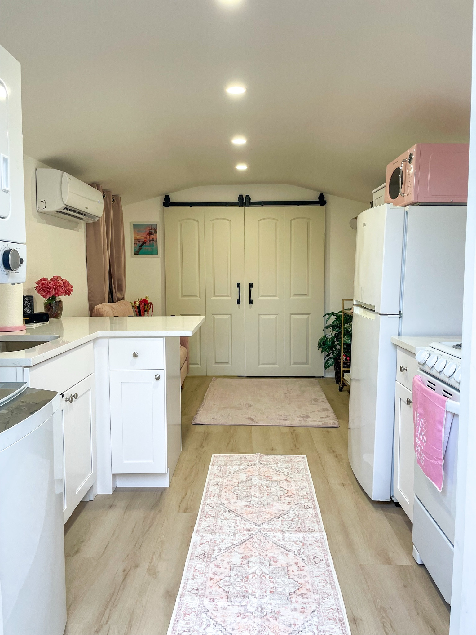 Clean, bright kitchen space with pink appliances — signature Casita style.