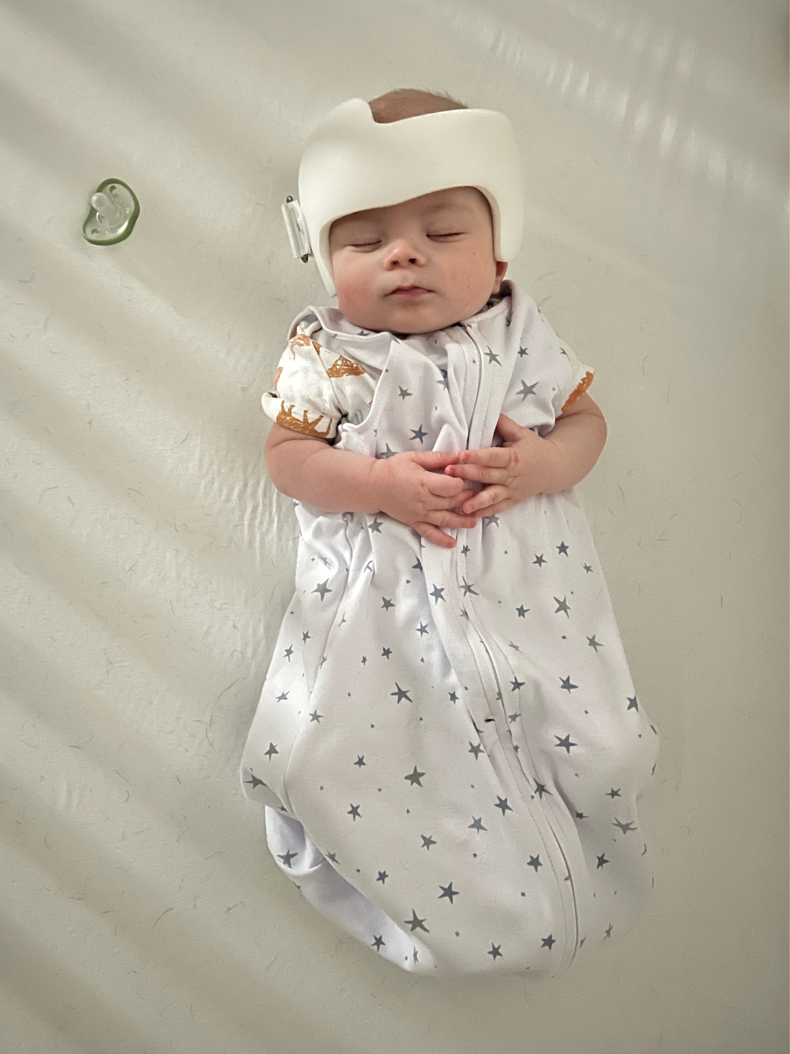 Loving this sleep sack to keep him cool overnight with the helmet! We usually just put him in a onesie or just the diaper under the sleep sack. If you keep your house really cold, a long sleeve onesie would be perfect under this sleep sack! 

Bear is in the 6-12 month size to allow for growth! 

Cranial helmet | sleep sack | baby sleep | baby onesie | diaper | sleep suit 