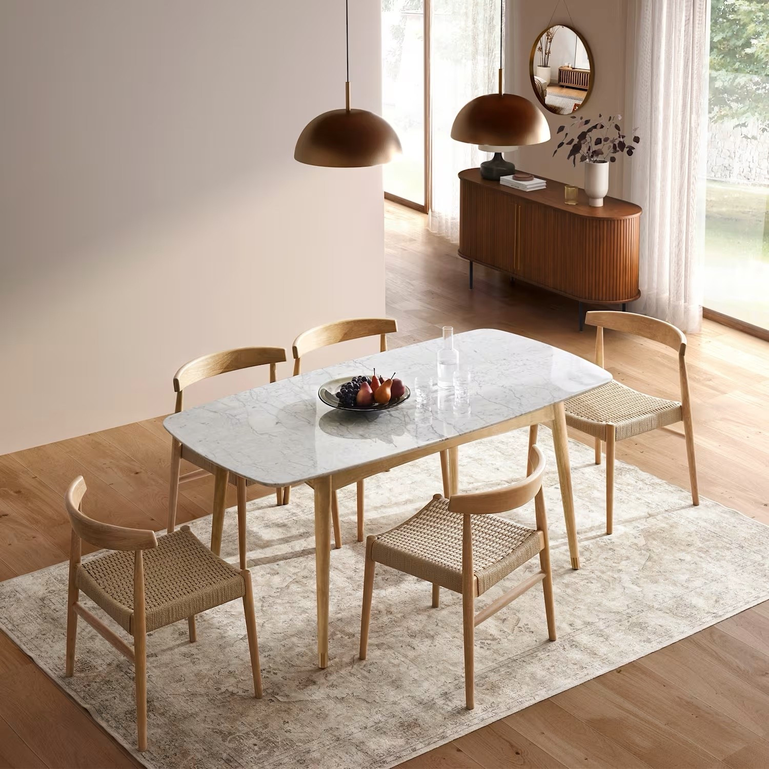 This light wood dining table with a marble-look top is such a beautiful blend of warm and refined — perfect for a modern, Scandinavian-inspired dining space. Paired with woven seat dining chairs, soft neutral textures, and warm brass lighting, it creates an inviting yet elevated look for everyday meals or hosting.
I’ve tagged the exact dining table, plus similar chairs, pendant lights, rugs, and sideboards to help you recreate this effortlessly chic dining room.