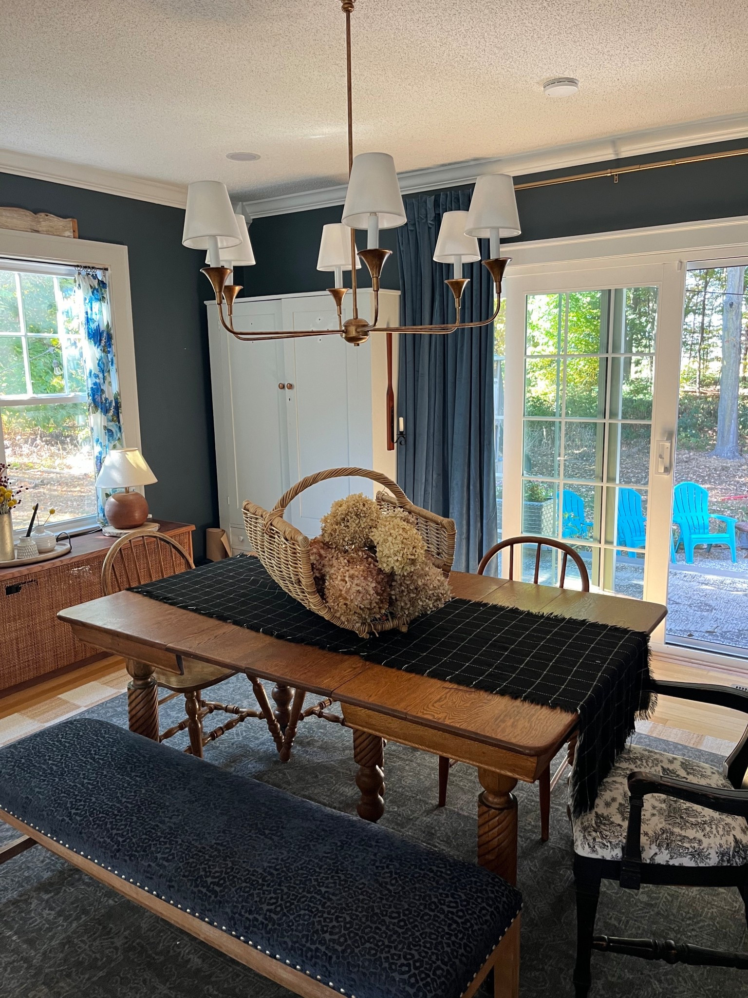 Cozy modern cottage dining room with layered rugs, dark paint and warm lighting. Wall color is Coffee Nook by Magnolia  

#LTKHome #LTKSeasonal