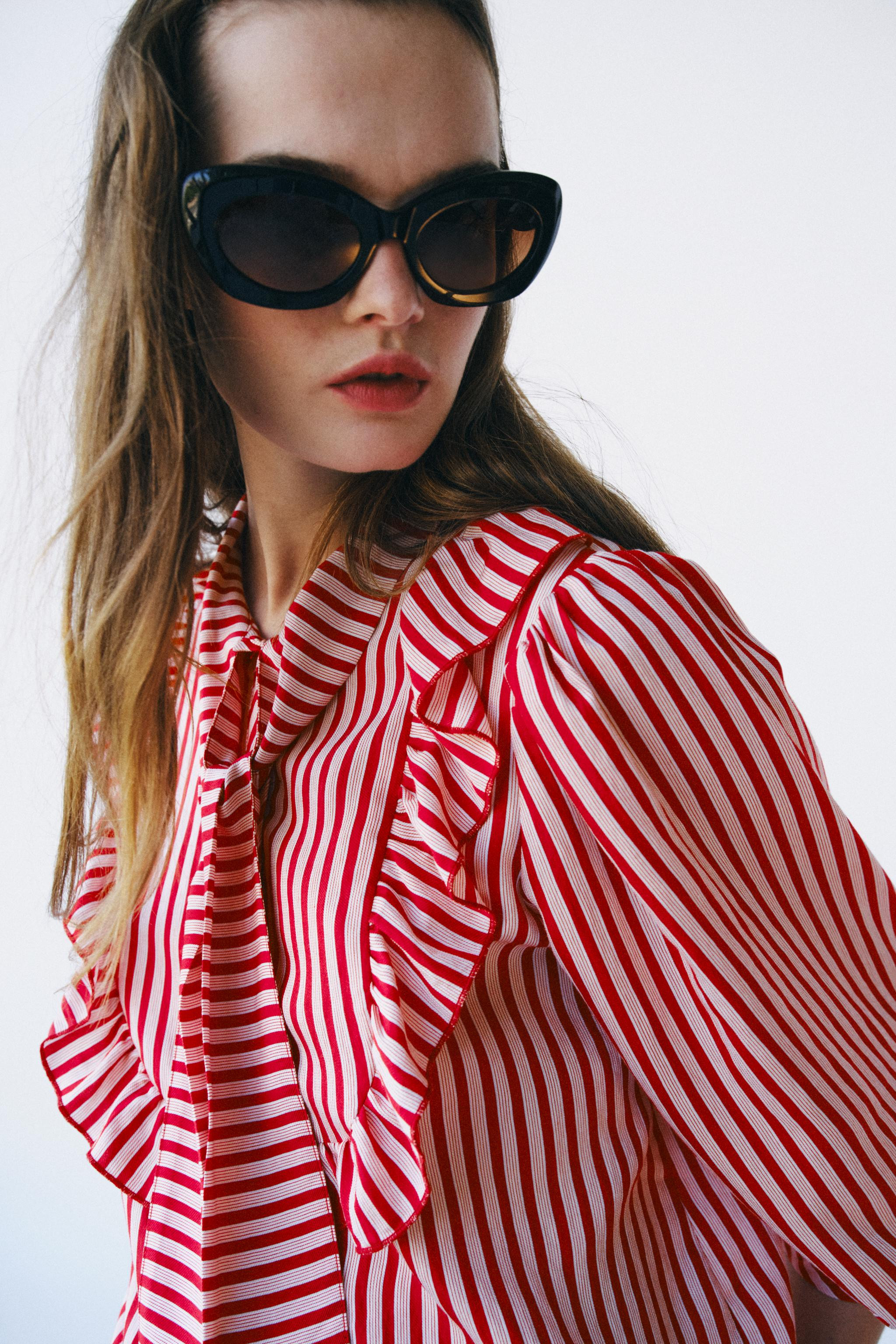 Long-sleeve blouse with a high neck and tie detail. Features front ruffles and a button-up placke... | Zara US