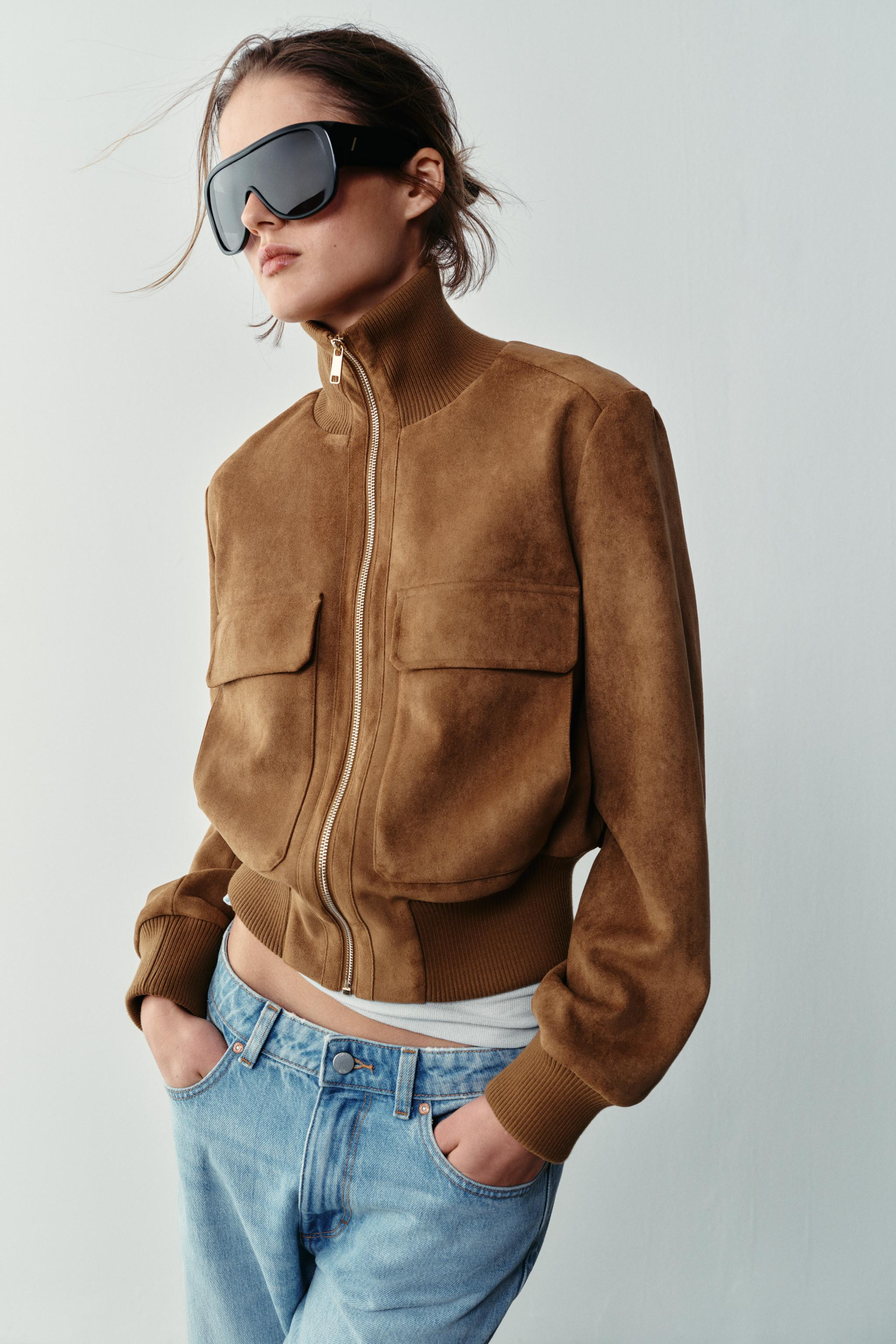 Bomber jacket with a stand-up collar and long sleeves. Front patch pockets with flaps. Ribbed tri... | Zara US