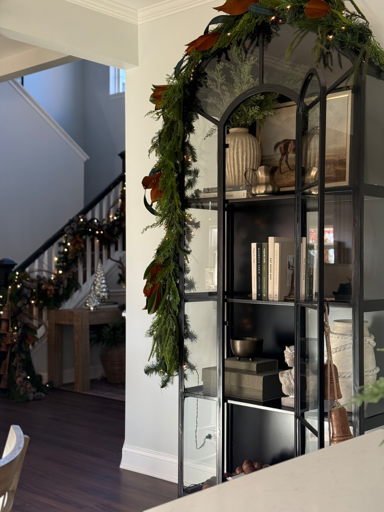 My black arched cabinet is dressed for the holidays with mixed greens garland over the top and a mix of vintage pieces with some new finds. 

#LTKHoliday #LTKHome #LTKFindsUnder50