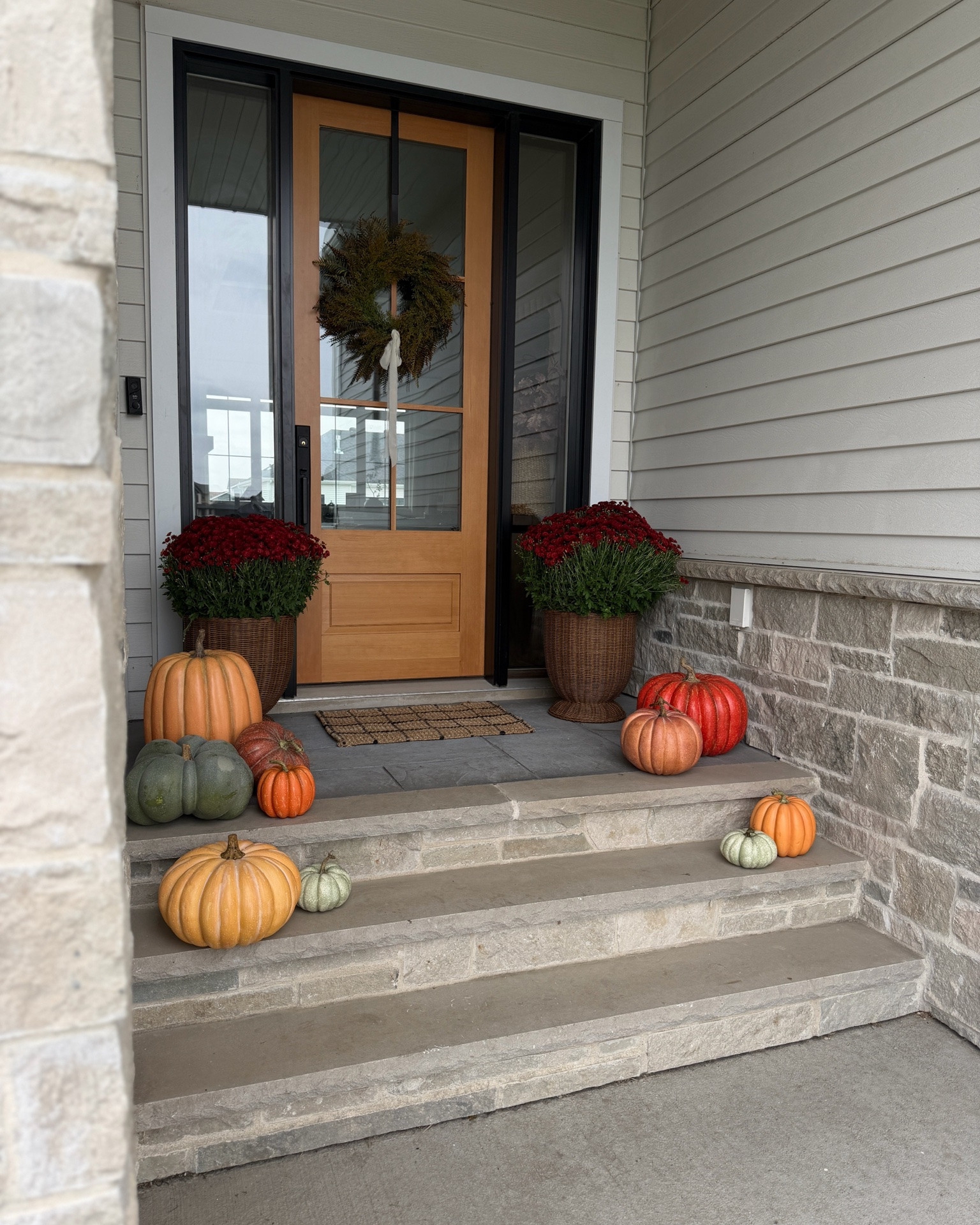 🤎 Our low key, minimal front porch! I love these faux pumpkins so much. People have been asking if they’re real because they look that realistic, and they are 50% off! I thought these huuuge mums from Costco and paired them with these Walmart planters and added this Amazon wreath to our front door. 

#frontporch #frontdoor #wreath

#LTKHome #LTKSeasonal #LTKSaleAlert