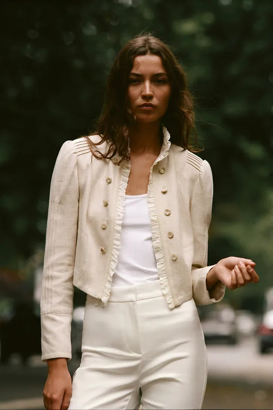 Open blazer featuring ruffles, long sleeves with shoulder pads, and pintuck detailing. Faux front... | Zara US