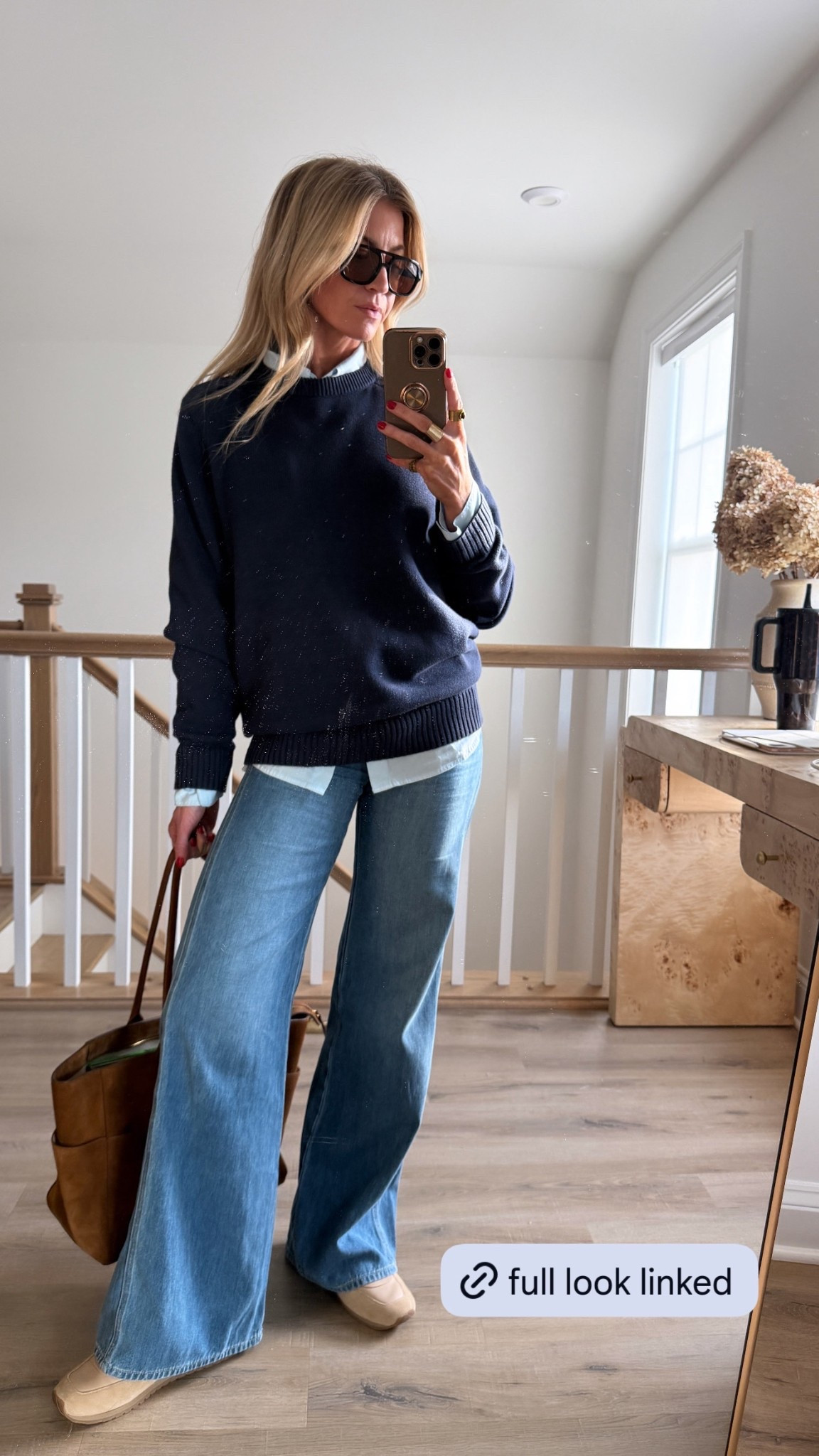Casual mom outfit for going to the kids school. 
Light blue button up: runs oversized, wearing a small
Navy cotton heritage sweater : ON SALE! 60% off! it’s a men’s, so it runs large, wearing a medium, currently on sale!
High rise mid rinse flare jeans: OM MAJOR SALE - $200 off! TTS, wearing a 25
Nude leather sneakers: run TTS
#LTKStyleTip 

#LTKmomlife #LTKootd #LTKdayinmylife