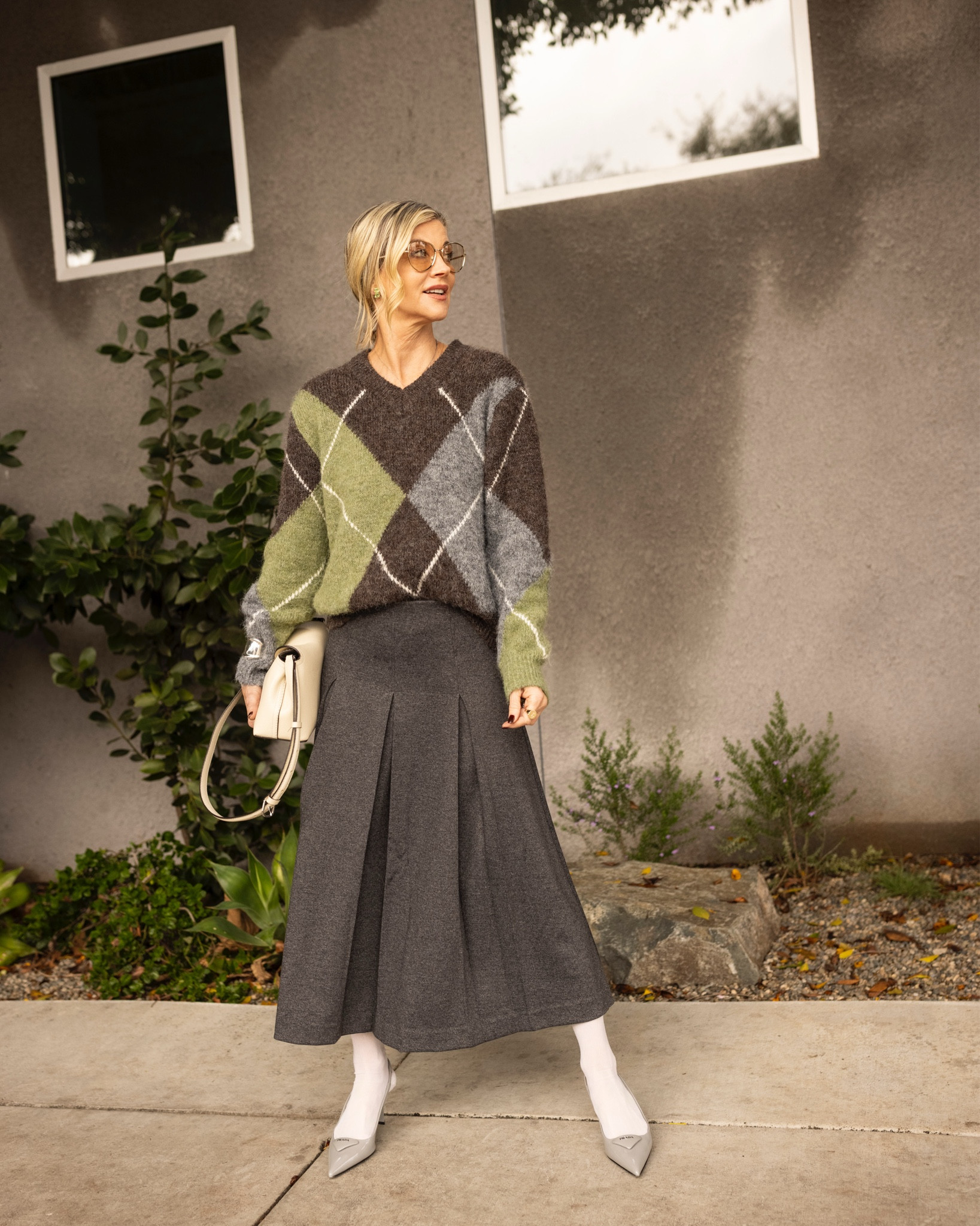 High + low dressing is how I love to build my personal style.
I love mixing an elevated piece or pieces with something more affordable—because the magic is in the styling, not the price tag.
       Comment shop for details⭐️
Today I paired a cozy argyle sweater with a flowy midi skirt, then finished it off with pointed-toe heels + a sleek bag for that polished look.
The sweater & skirt are a great price! 

The white hose with heels, it makes the outfit feel editorial, European, and intentionally styled.
My tinted frames are 6 years ago. 

Investment: bag / heels
Affordable: sweater / skirt / hose
Style trick: tonal neutrals + sharp pointed toe.

Tell me… are you a high/low too?

Style tip: keep the color palette neutral and intentional, and suddenly everything looks luxe—even if it isn’t


#LTKPetite #LTKdayinmylife #LTKSeasonal